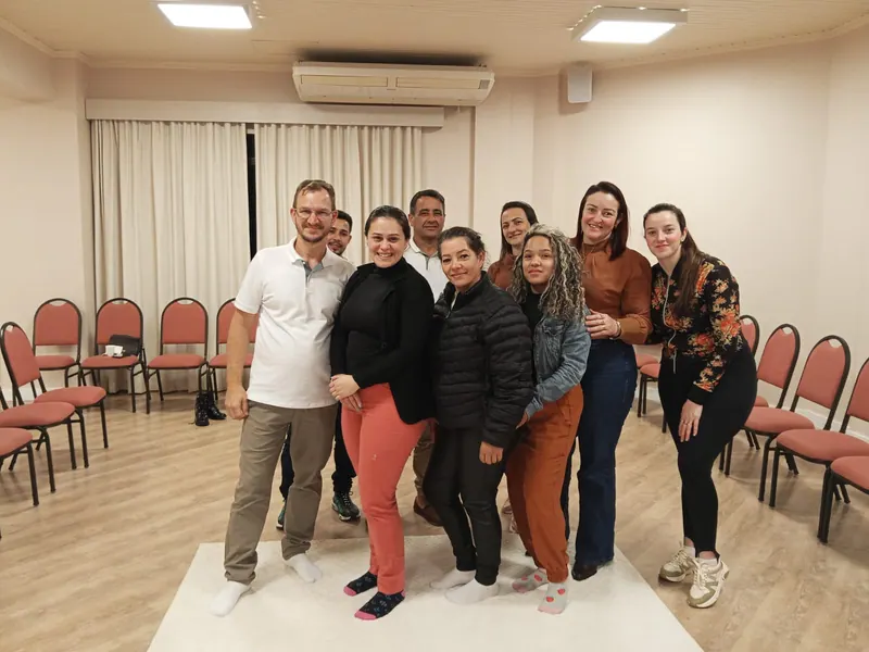 Edilson com o grupo de participantes depois de um evento de constelação, numa sala com cadeiras